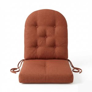 Custom high-back tufted chair cushion in rust orange with rounded top and secure ties