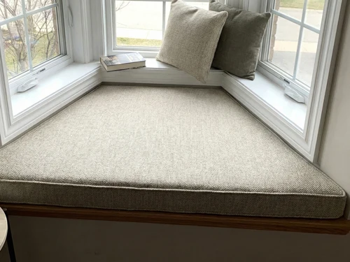 Custom cushion fitting perfectly on oddly-shaped window seat bench