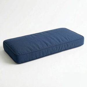 a rectangular navy blue custom-sized bench cushion with a soft fabric texture and professional piped edges, isolated on a white background.